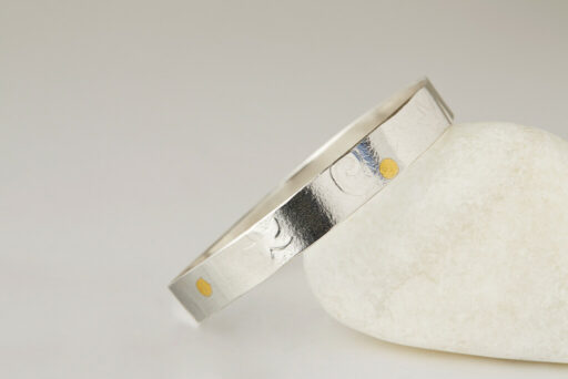 Embossed bangle with starfish and swirl