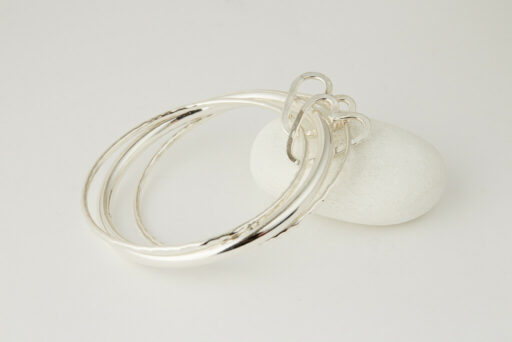 Three Recycled Silver Bangles Connected with a Bronze & Silver Disc - Image 4